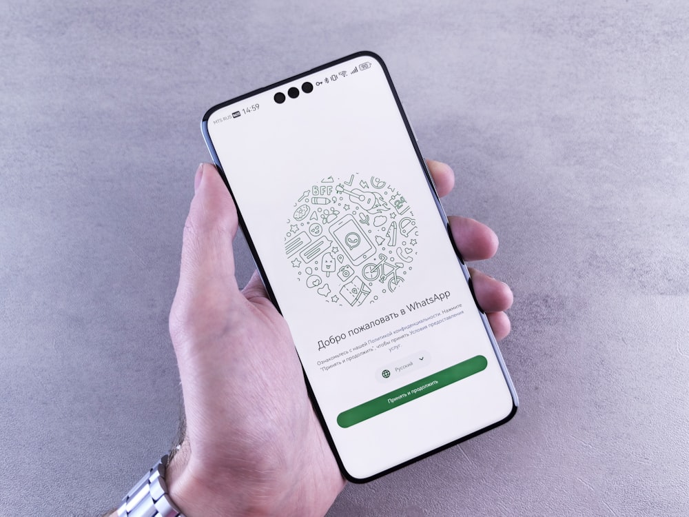 Hand holding phone with WhatsApp fashion search chat